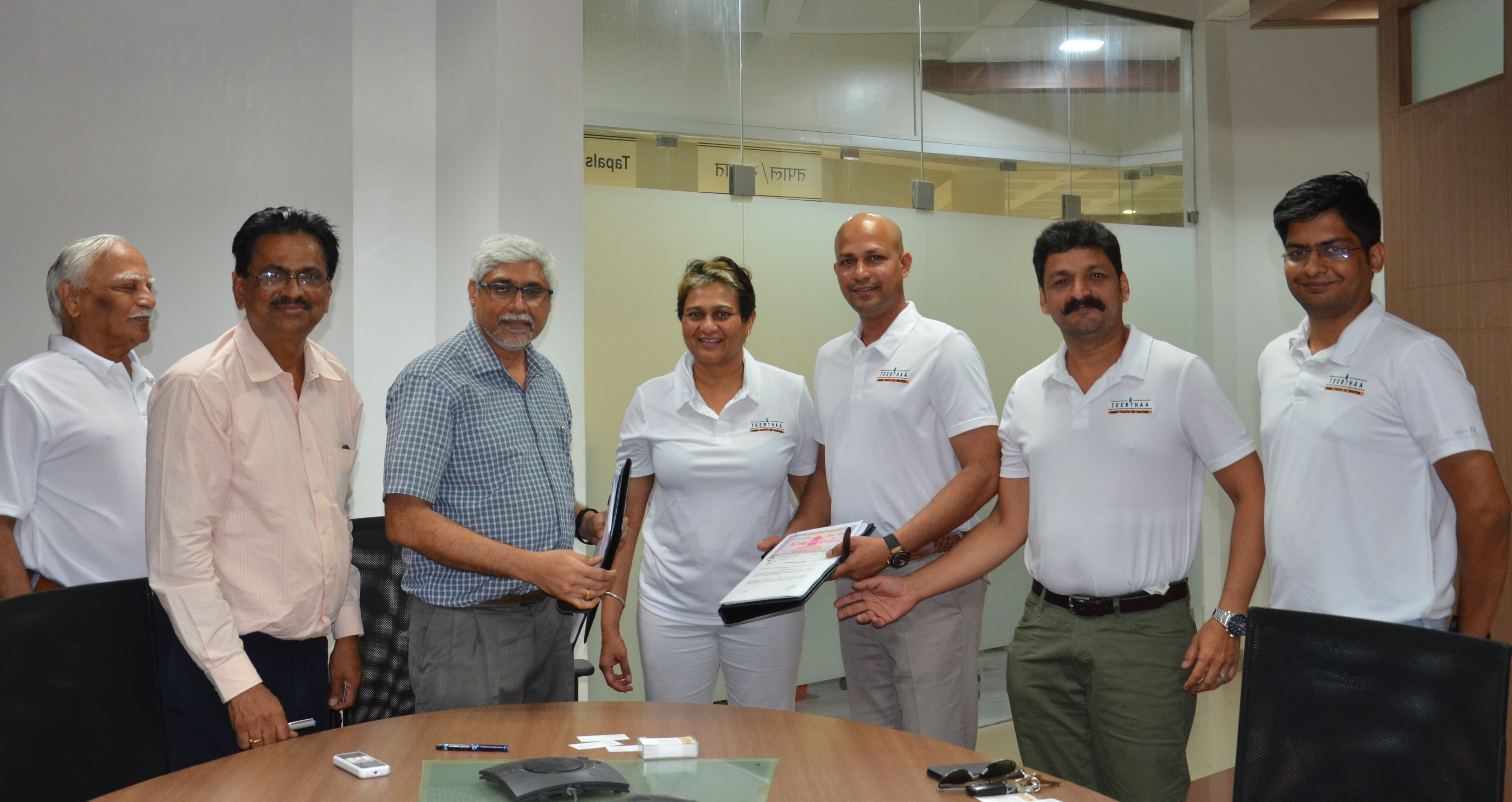 Prof. Ravindra Gettu (3rd LEFT), Dean (ICSR), IIT Madras, & Ms. Durga Das (4th LEFT), CEO of Teerthaa, displaing the MoU on collaboration.jpg